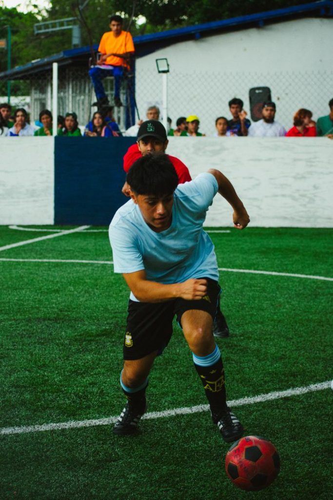 Players in dynamic action during a soccer match in Mexico City, capturing raw athletic energy.